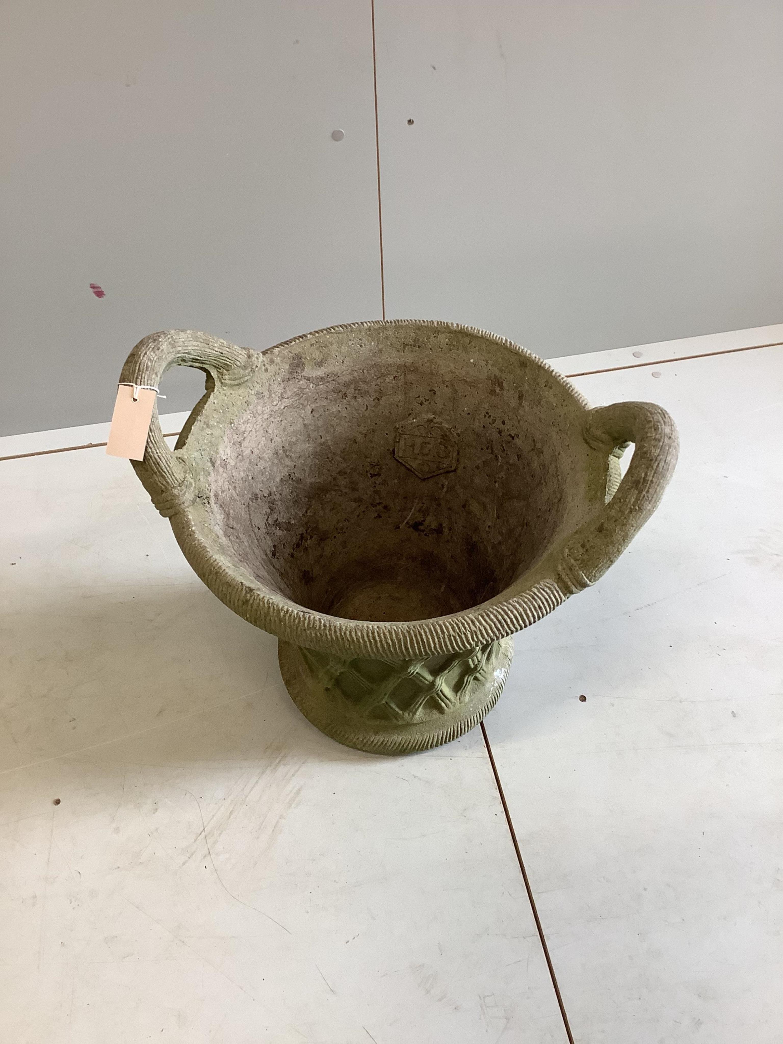 A circular reconstituted stone garden planter, width 54cm, height 48cm. Condition - fair